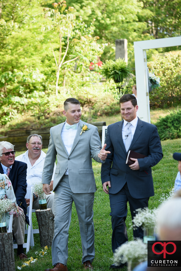 Teh groom walks down the aisle.