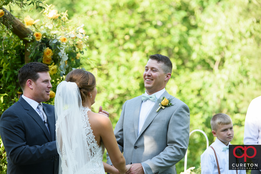 Groom smiling during the ceremony.