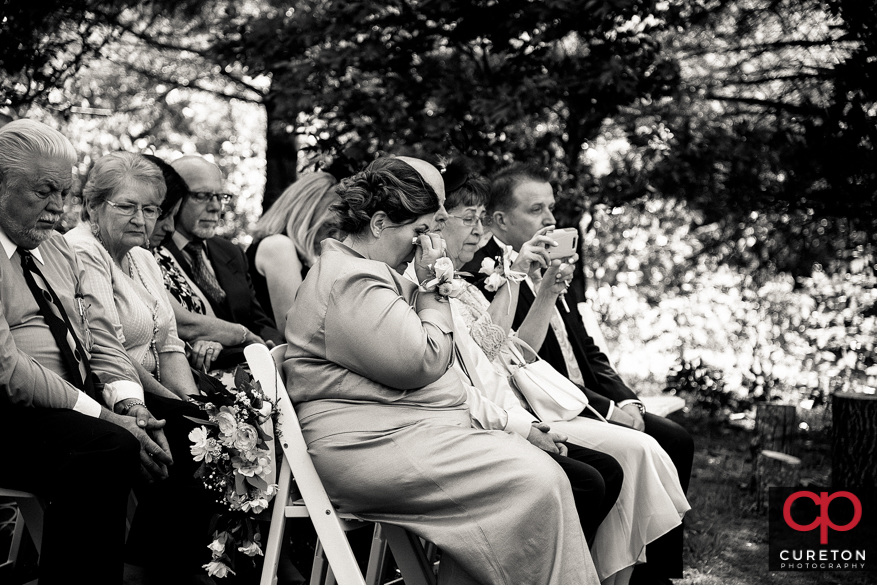 Mother of the bride tearing up.