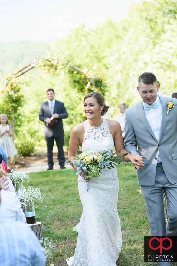 Bride and groom walk back down the aisle.