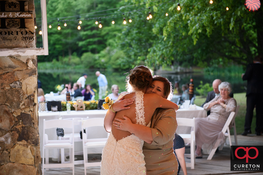 Bride and her mom dancing.