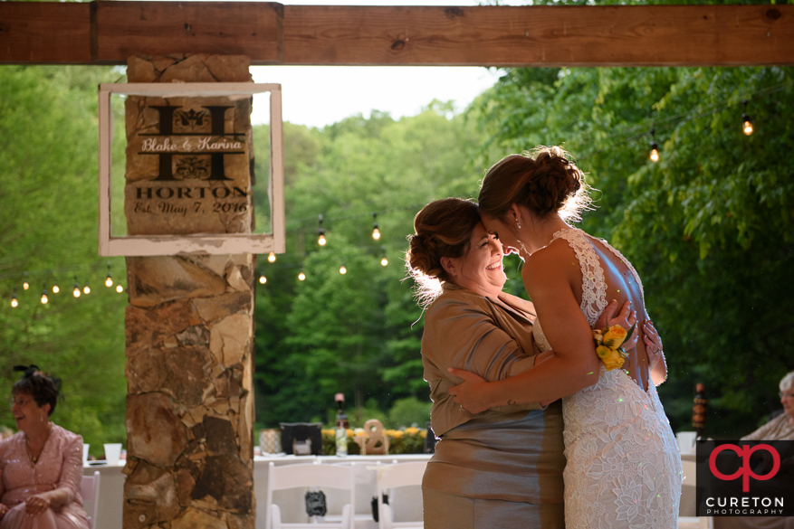 Bride and her mom dancing.