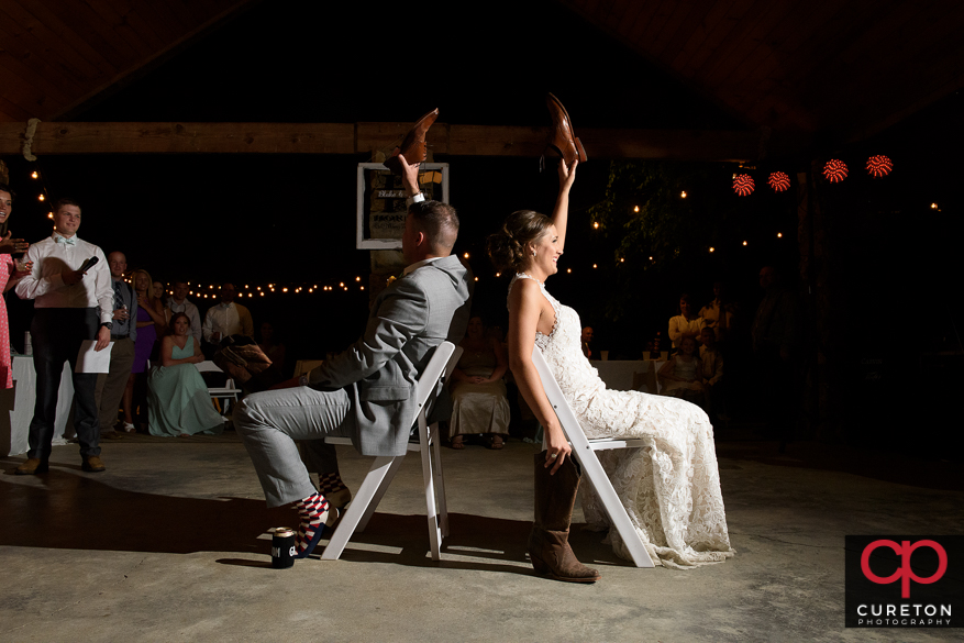 Bride and groom play the shoe game.