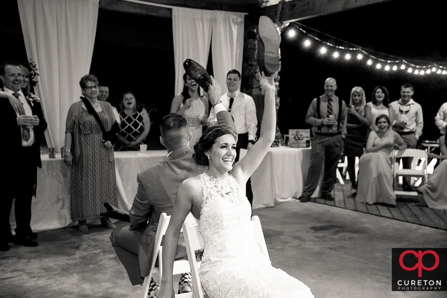 Bride and groom play the shoe game.