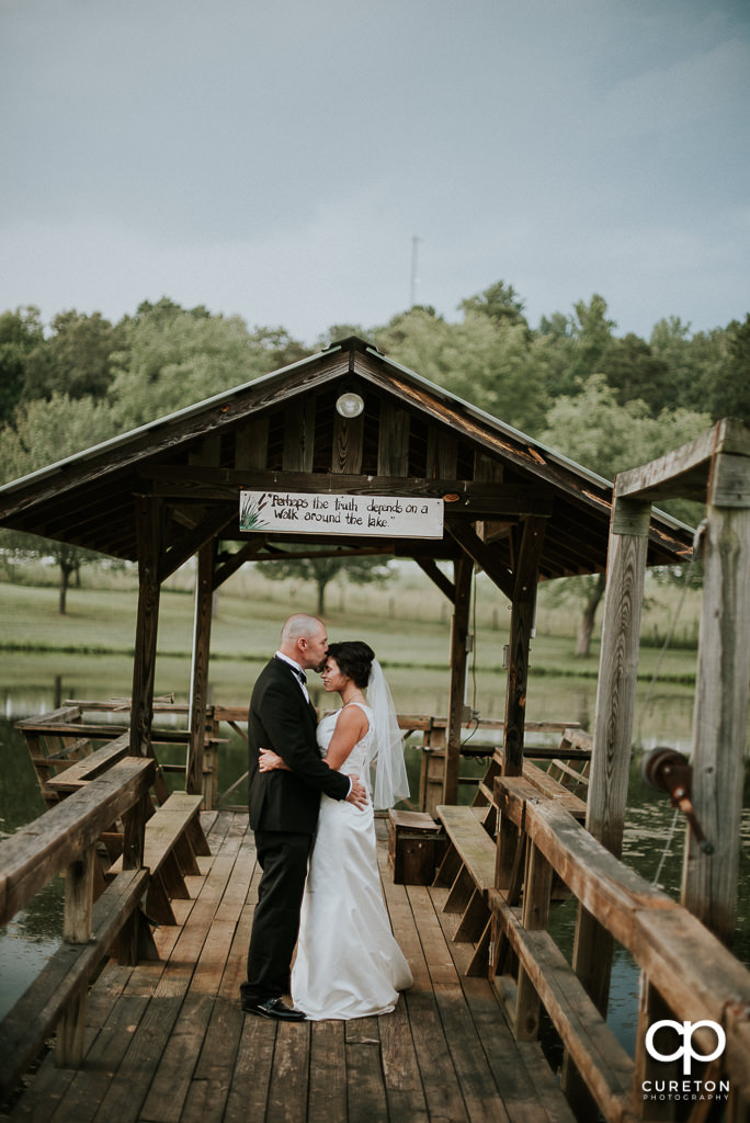Groom kissing his bride on the forehead at the South Wind Ranch, a wedding venue in Travelers Rest, SC.