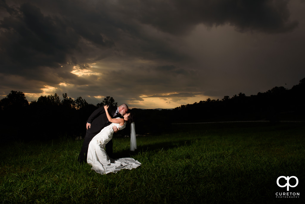 Bride and groom dipping after their wedding at South Wind Ranch in Travelers Rest SC.