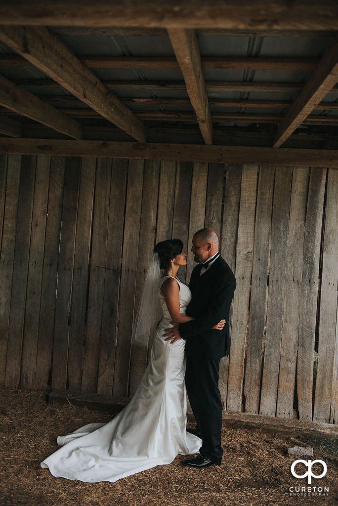 Bride and groom in the barn at South Wind Ranch.