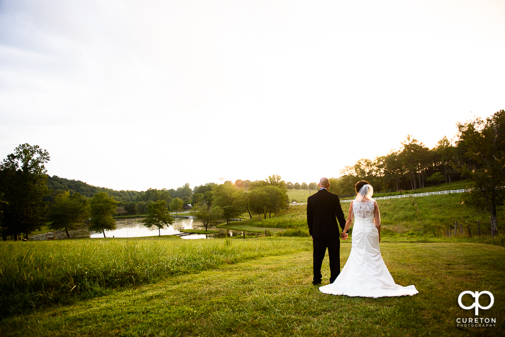 Bride and groom looking at the lake at the South Wind ranch.