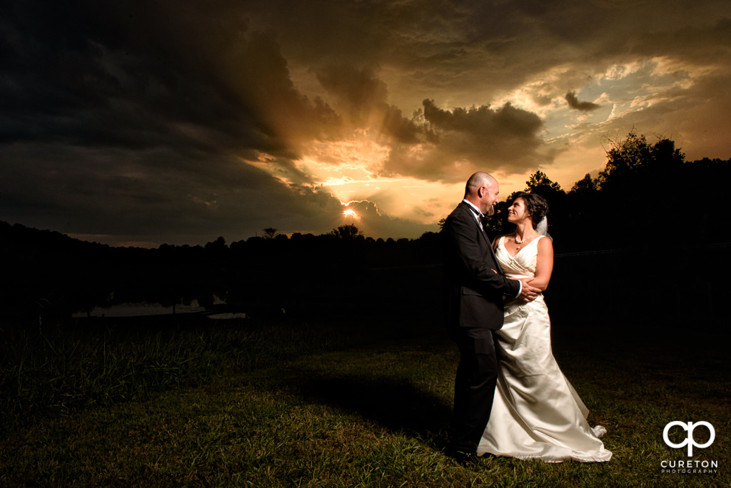 Bride and Groom staring at each other at sunset after their wedding at South Wind Ranch in Travelers Rest SC.