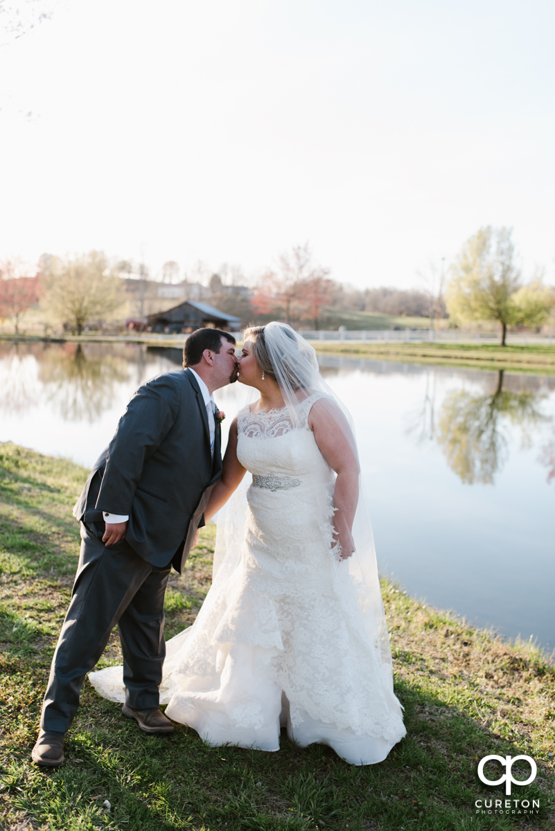Bride and groom kissing after their ceremony at South Wind Ranch in Travelers Rest SC on their wedding day.