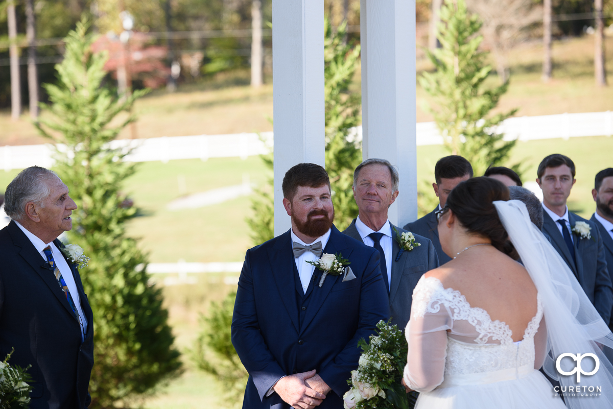Groom sees his bride walking down the aisle.