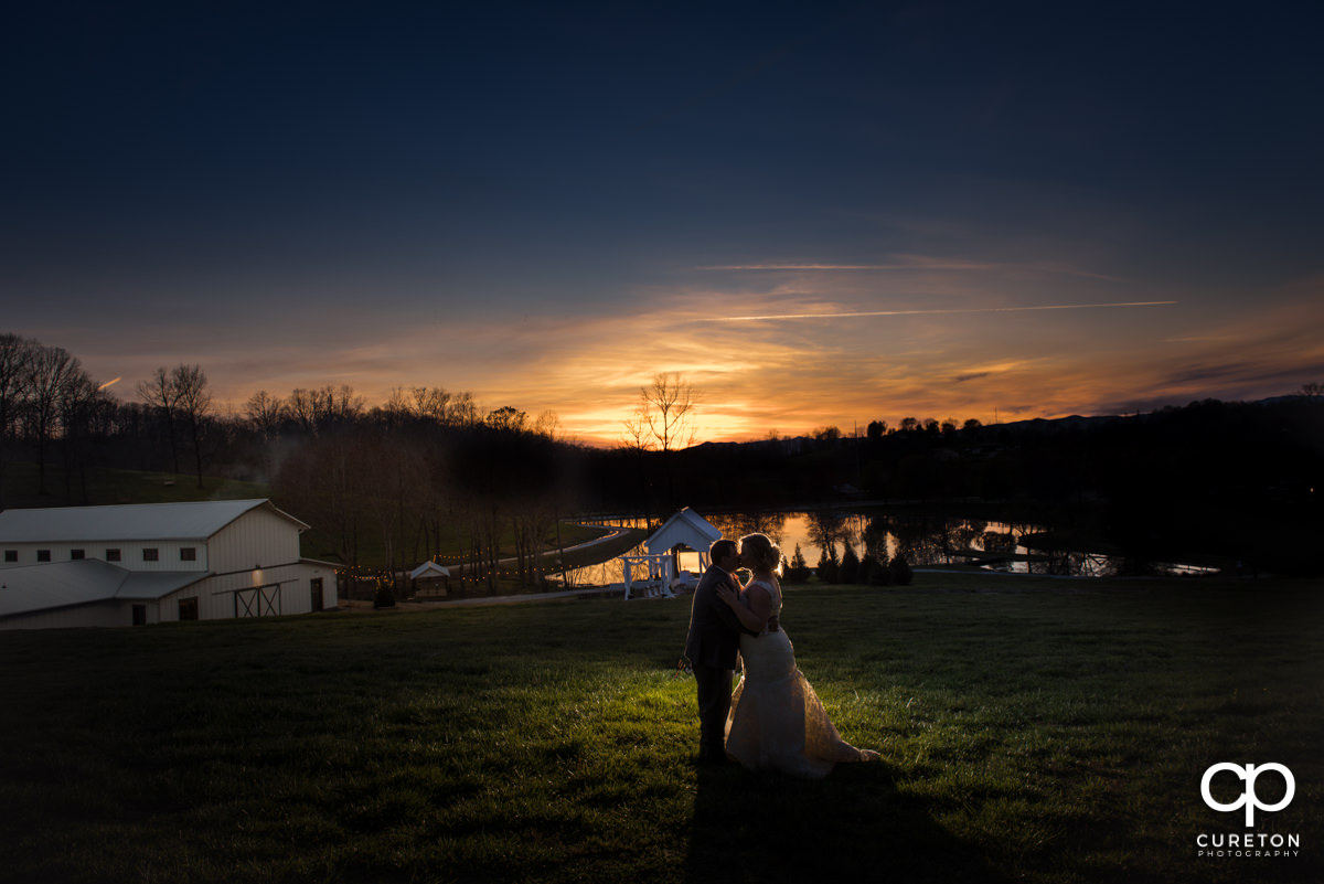 Bride and groom silhouette at South Wind Ranch on their wedding day.
