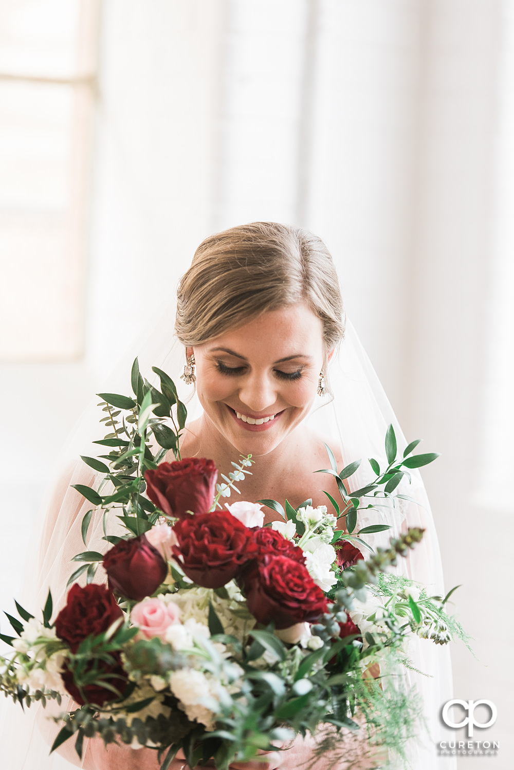 Bride laughing during her bridal session at The Southern Bleachery wedding venue at the Taylor Mill.