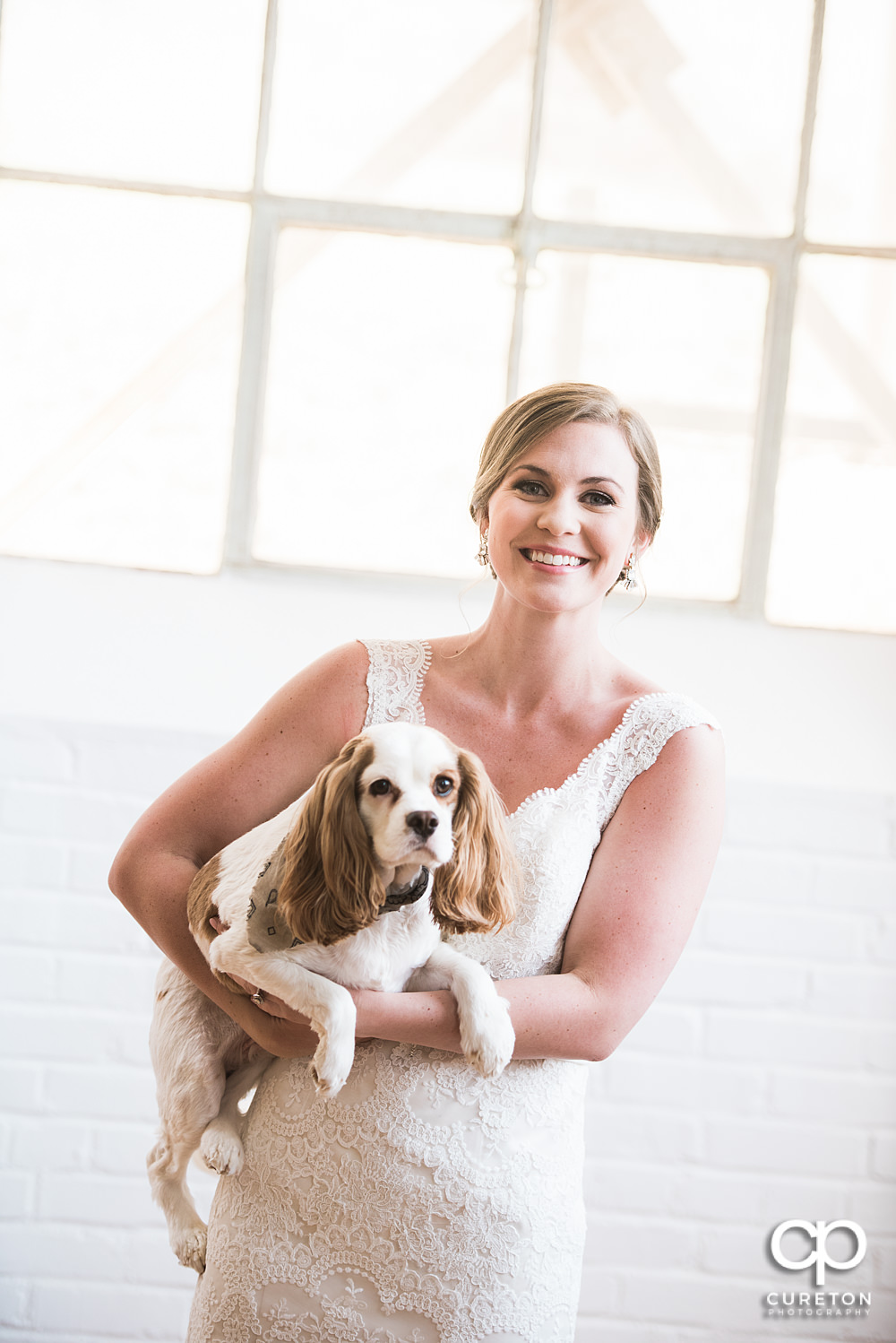 Bride holding her dog during her bridal session.