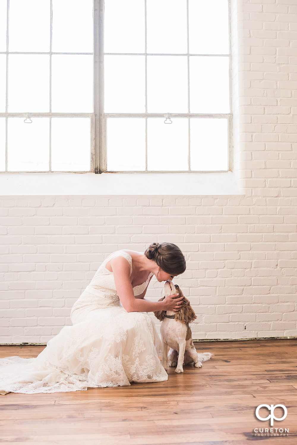 Bride kissing her dog during her bridal session.