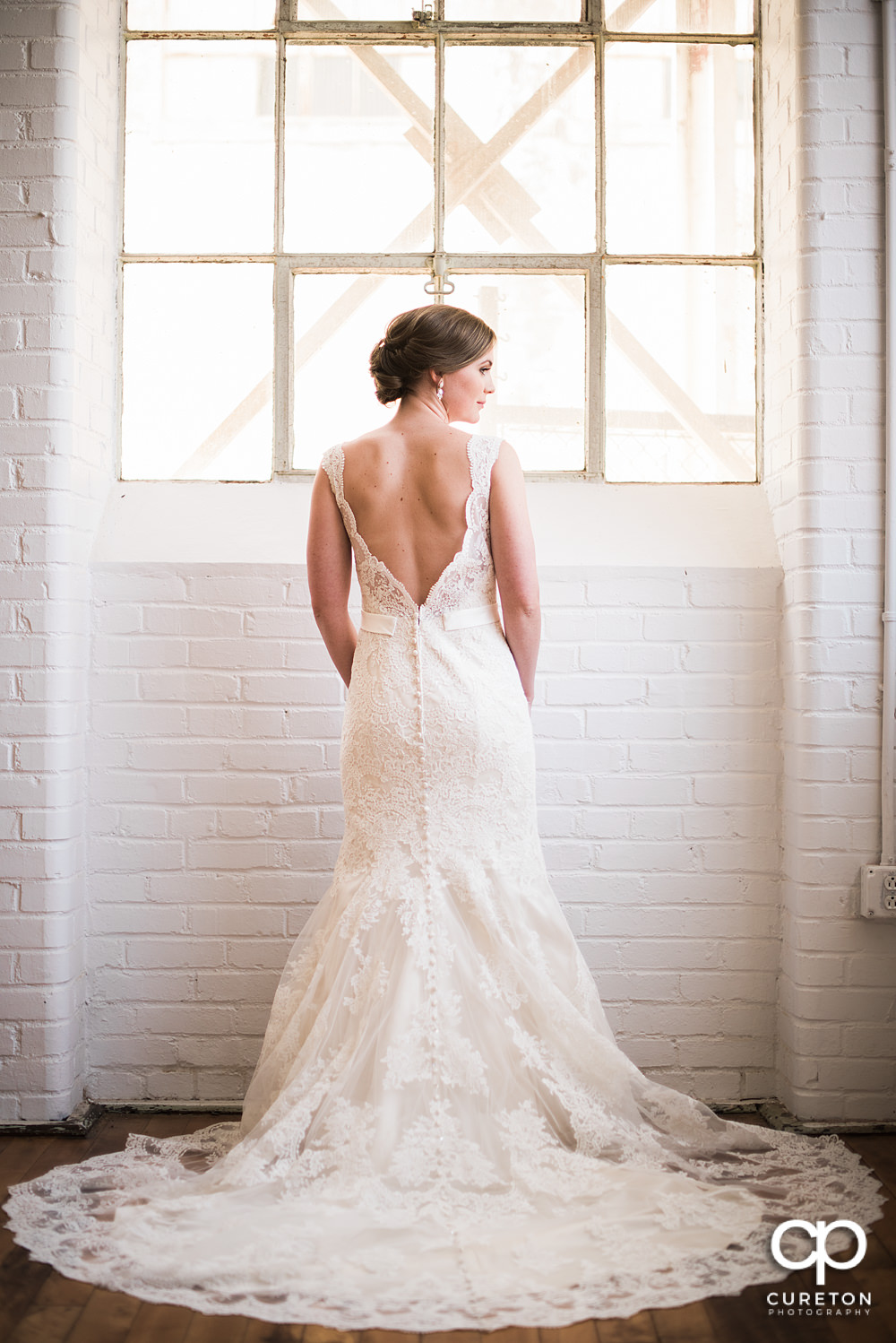 Teh back of the brides dress during her bridal session at Southern Bleachery.