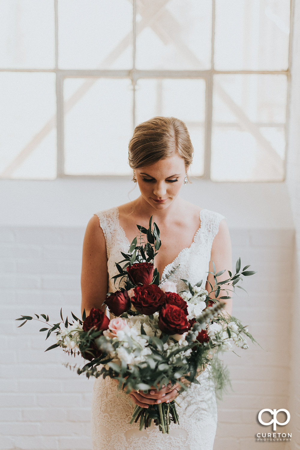 Bride looking at her flowers at the Southern Bleachery.