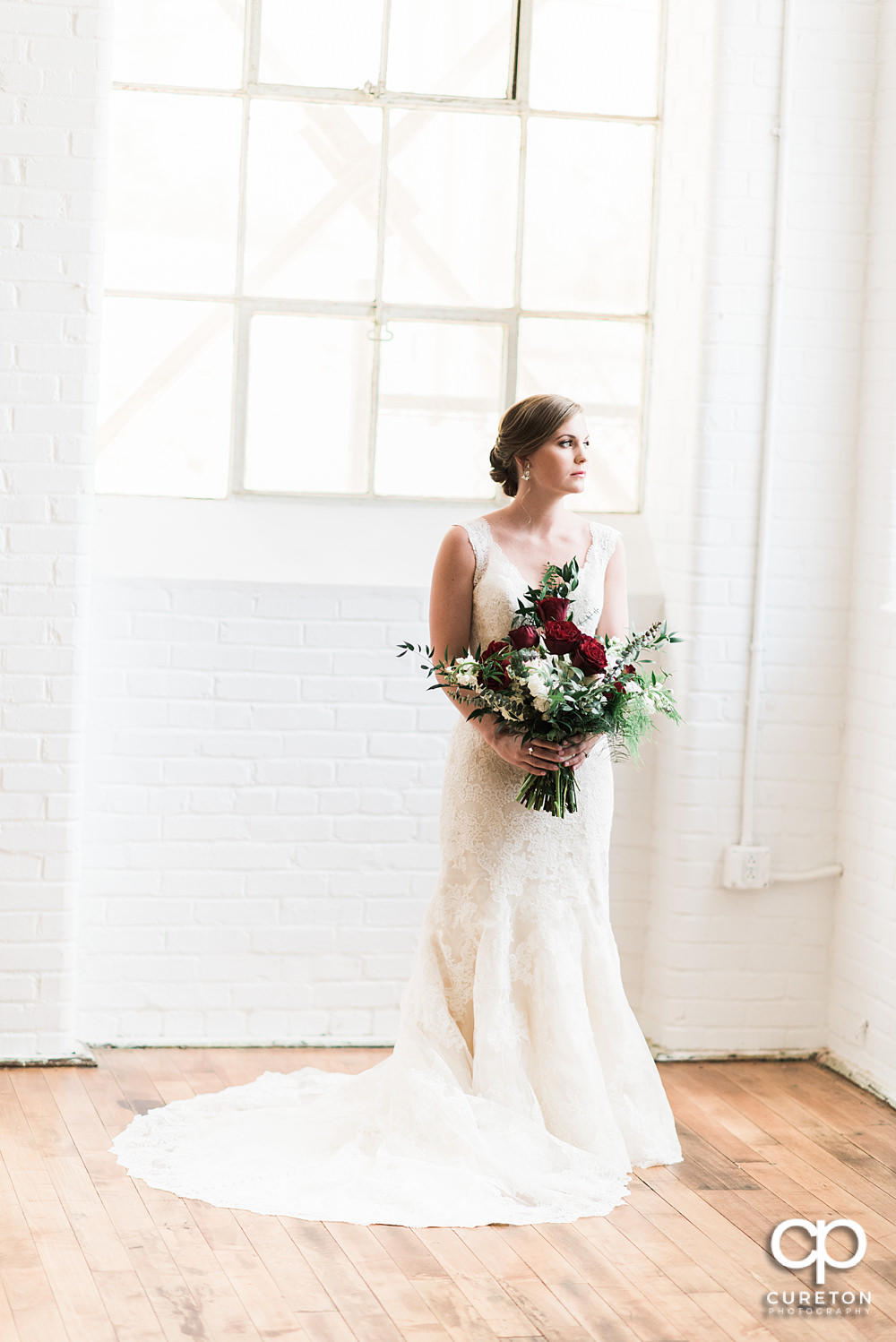 Bride holding her flowers bridal session at The Southern Bleachery wedding venue at the Taylor Mill.