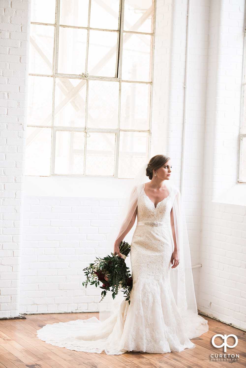 Bride looking out the window at Southern Bleachery.