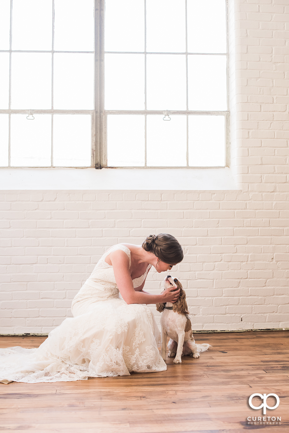 Bride kissing her dog.