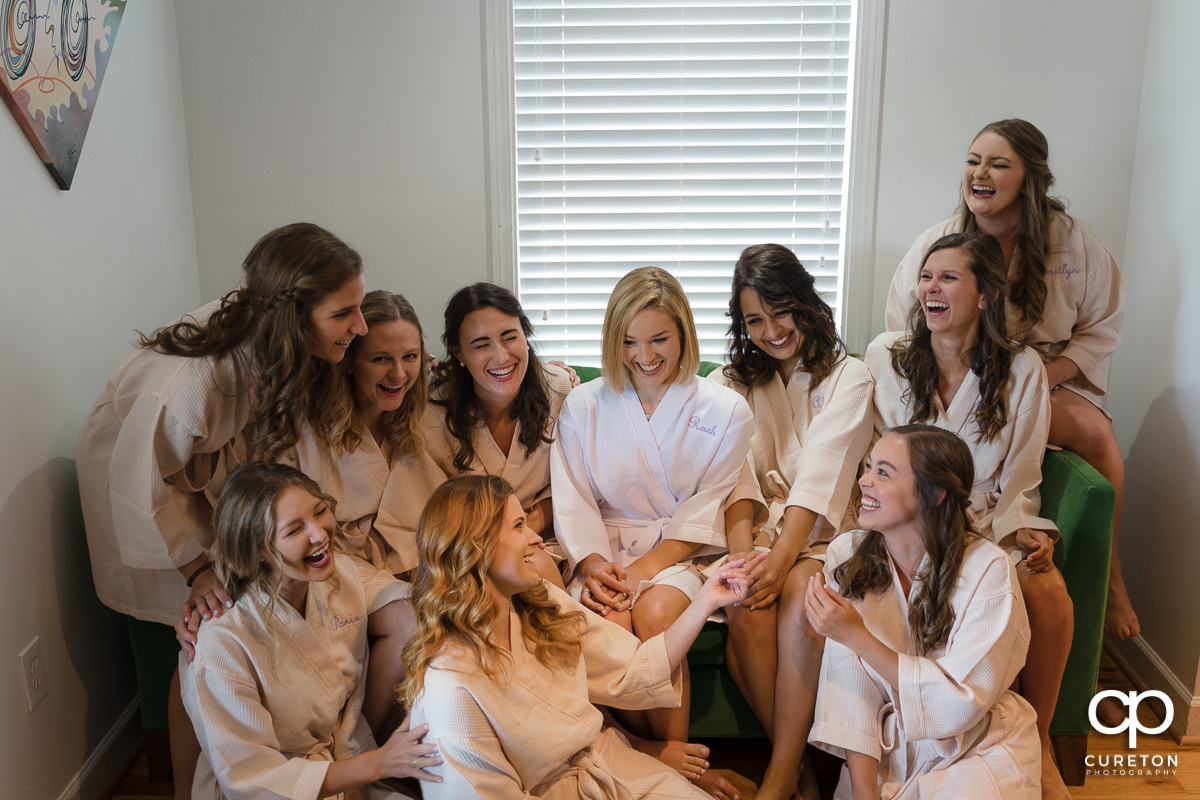 Bride and bridesmaids hangin out in their robes before the wedding.