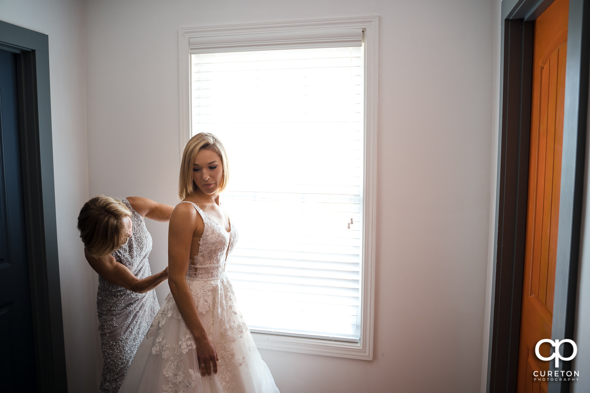 Bride and her mom getting ready for the wedding at The Swamp Rabbit Inn in Greenville,SC.