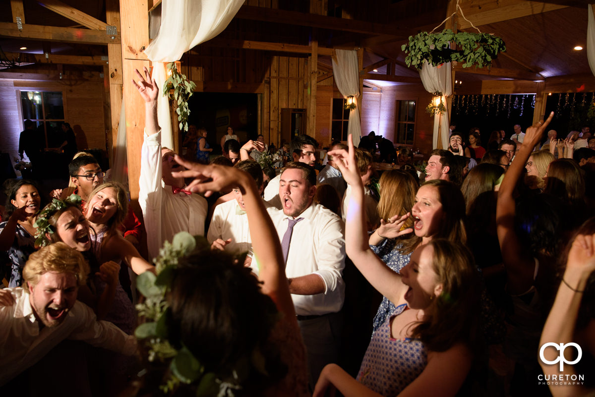 Guests dancing at the wedding reception at South Wind Ranch in Travelers Rest,SC.