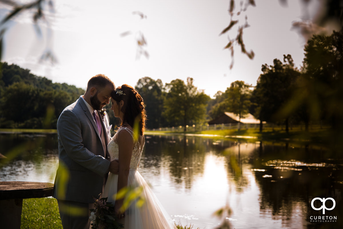 Bride and groom at the South Wind Ranch pond.