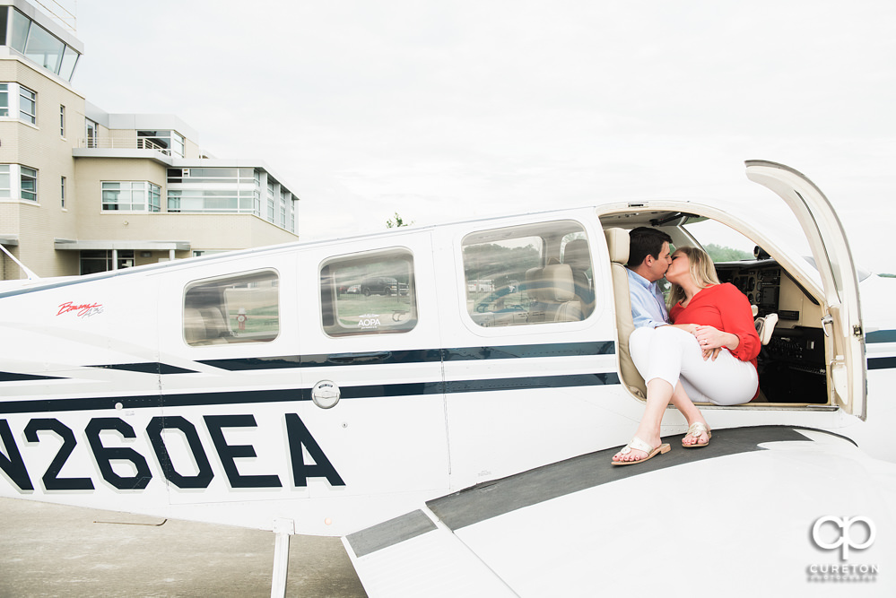 Engaged couple kissing during a Spartanburg Airport engagement session.