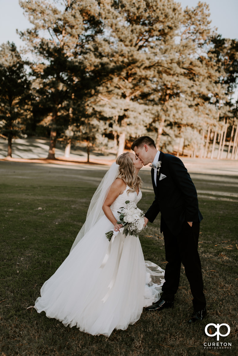 Bride kissing her groom after their Spartanburg Country Club wedding.