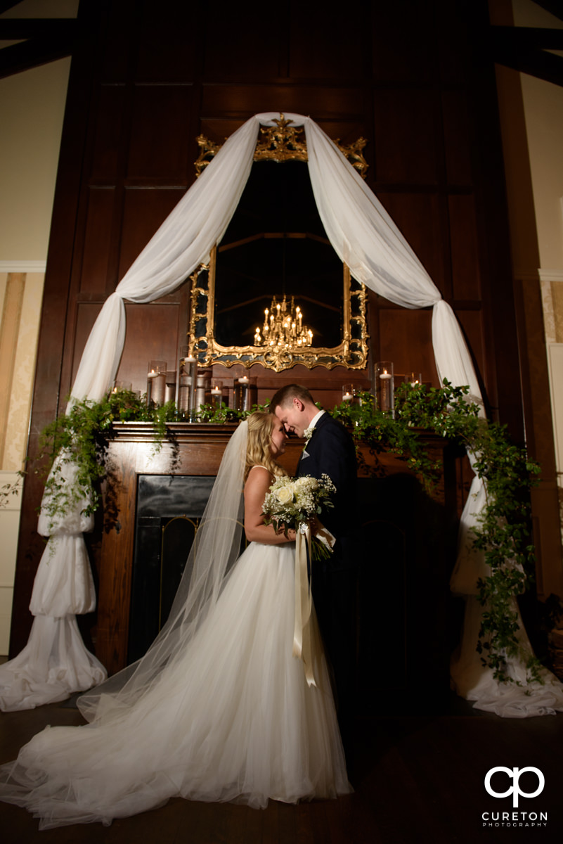 Bride and groom at the alter of their wedding inside Spartanburg Country Club.