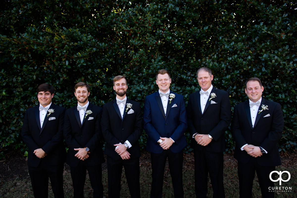 Groom and groomsmen hanging out before the wedding ceremony.