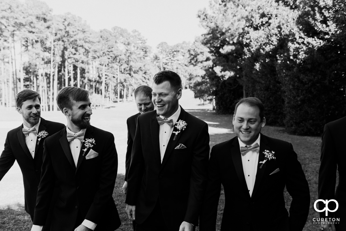 Groom laughing with his groomsmen before the ceremony.