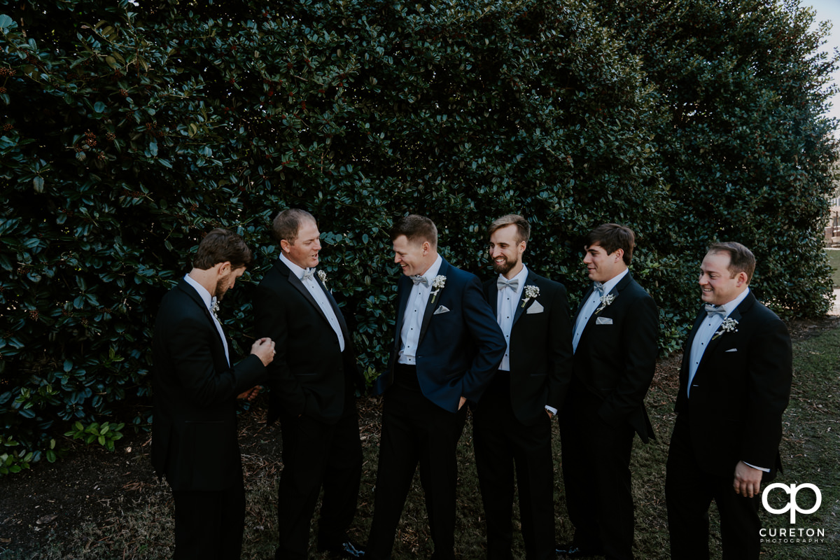 Groom and the groomsmen hanging out before the wedding ceremony at Spartanburg Country Club.