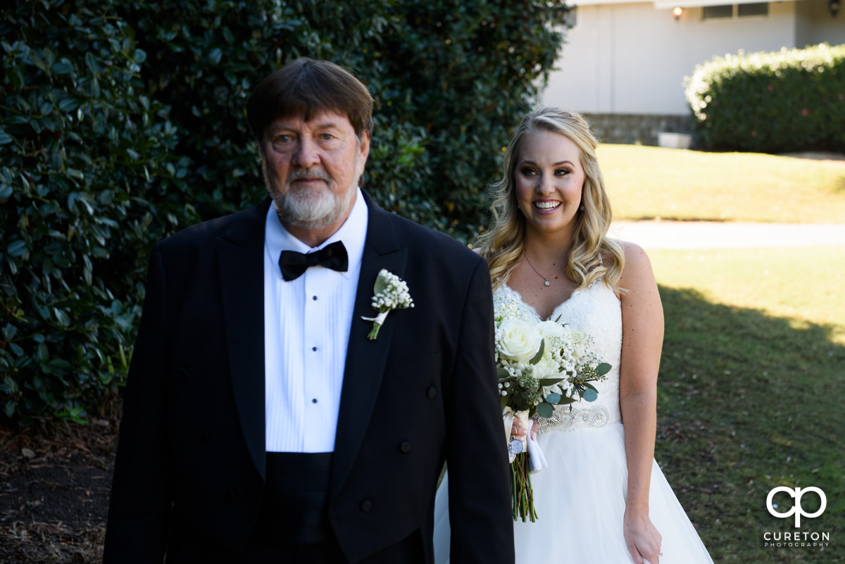 Bride walks up to her father for her first look before the wedding