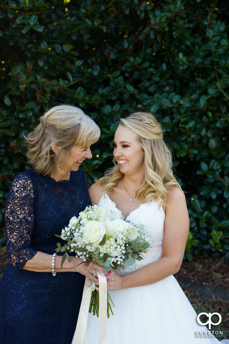 Bride and her mother sharing a moment before the ceremony.