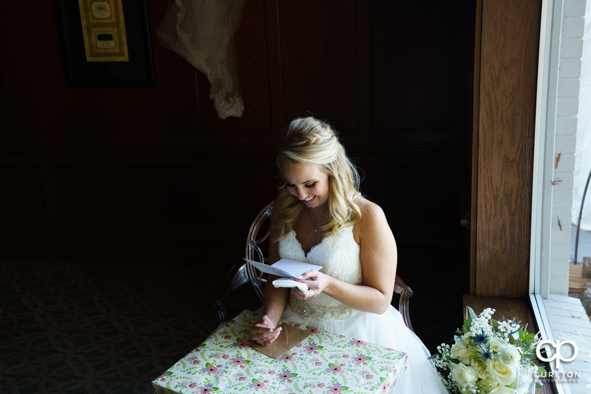 Bride reads a letter from her husband.