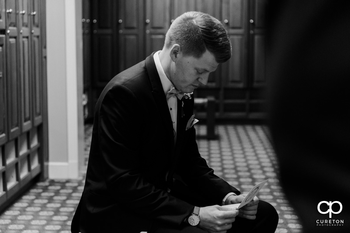 Groom reads a letter from his bride.