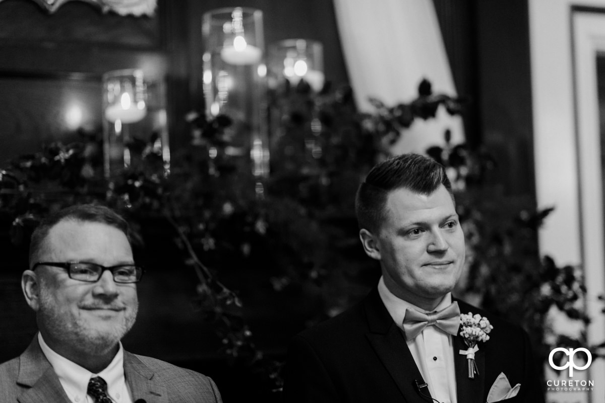 Groom with tears in his eyes as he sees his bride walking down the aisle.