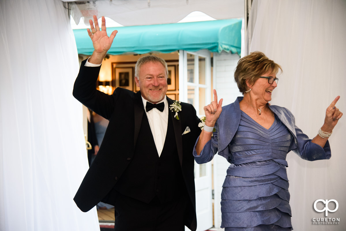 Parents of the groom making an entrance into the wedding reception.