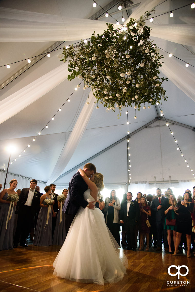 Epic first dance underneath a hanging floral installation at the Spartanburg Country Club wedding reception.