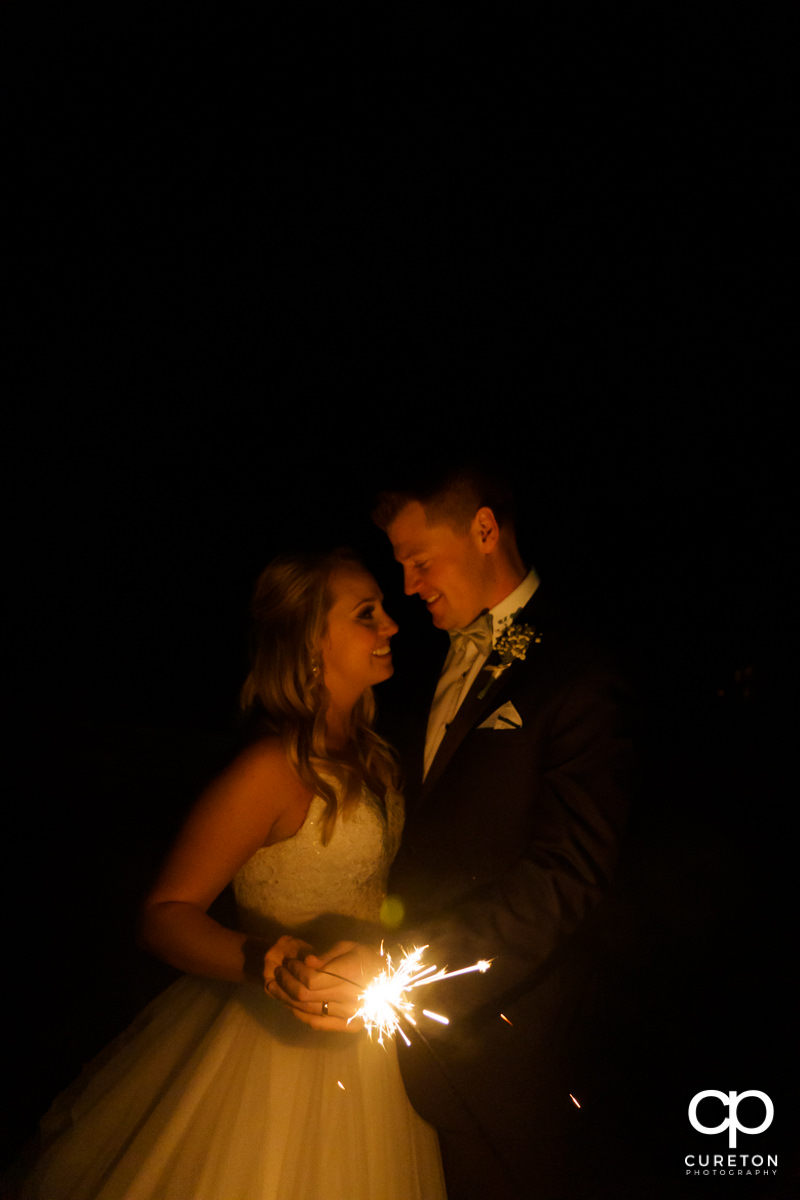 Bride and groom holding a sparkler.