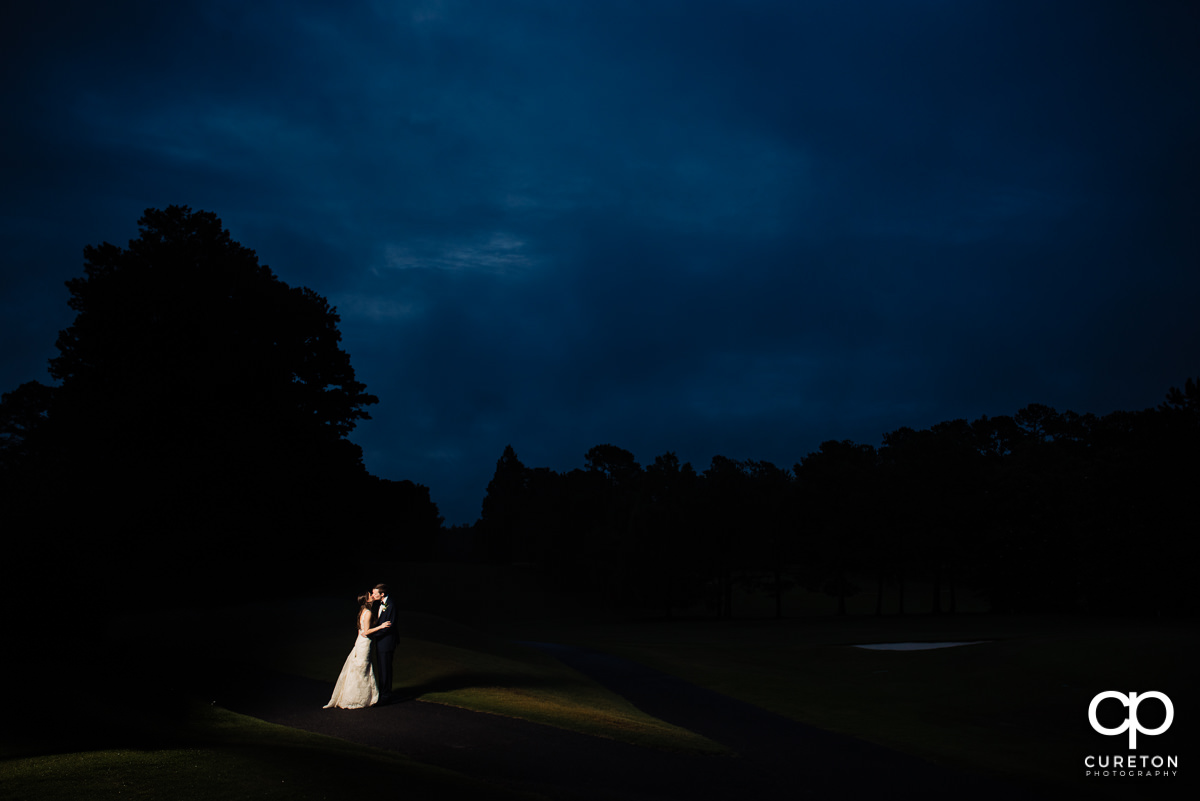 Bride and groom at sunset on the golf course at their wedding reception at Spartanburg Country Club.