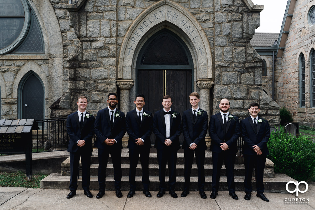 Groom and groomsmen standing outside of an antique church in Spartanburg.