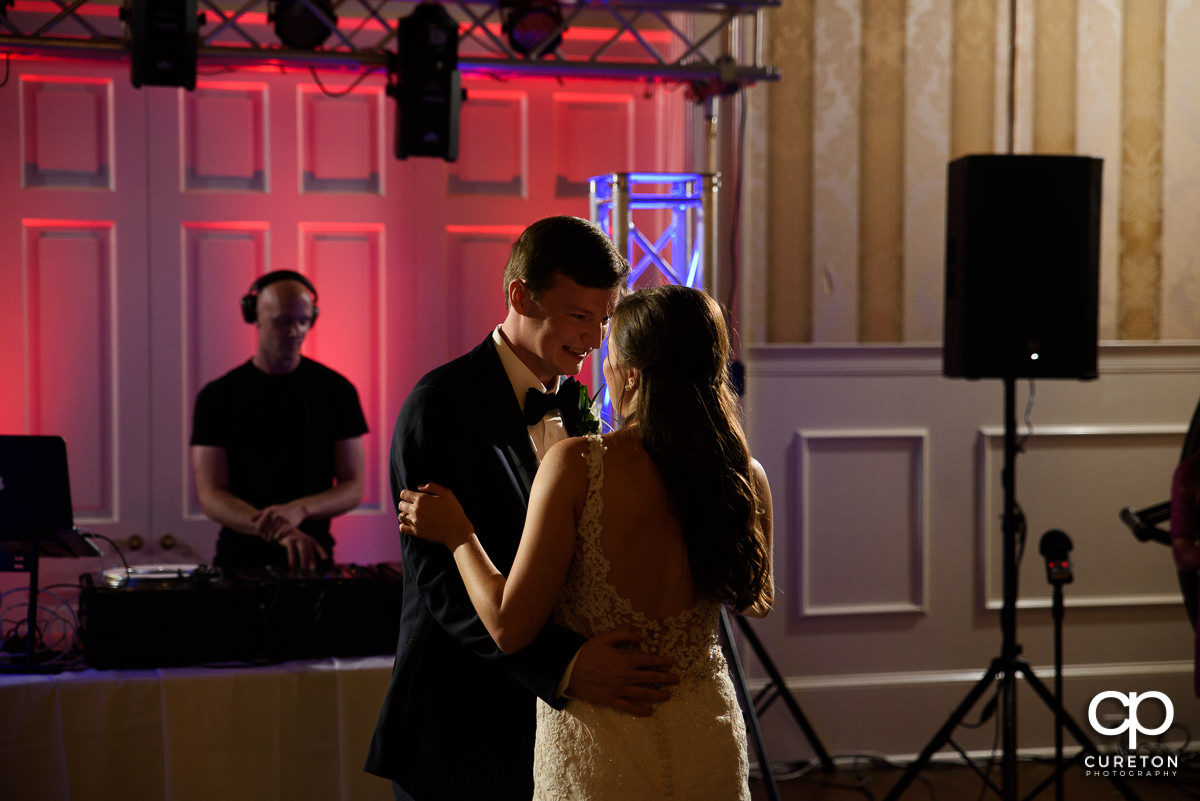 Groom smiling at his bride during the first dance at the wedding reception at Spartanburg Country Club.