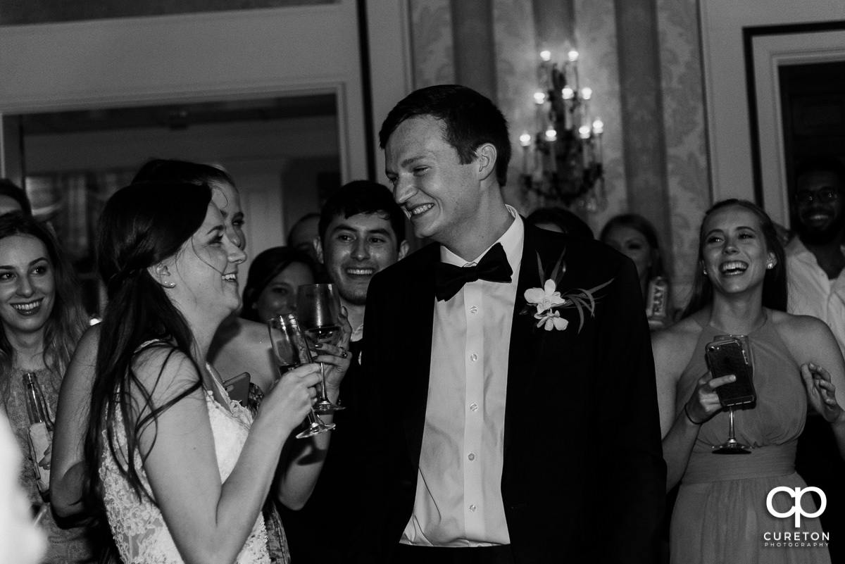 Bride and groom laughing at a wedding speech.