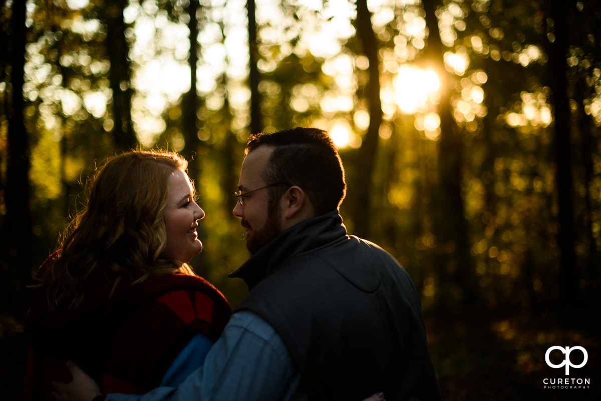Future bride and groom looking at each other during a golden hour save the date session.