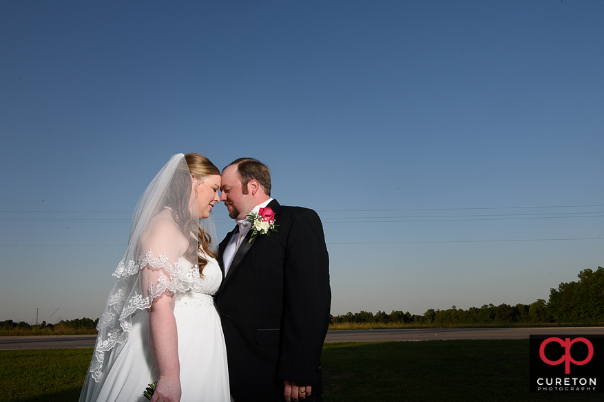 Couple cuddlling after their wedding.