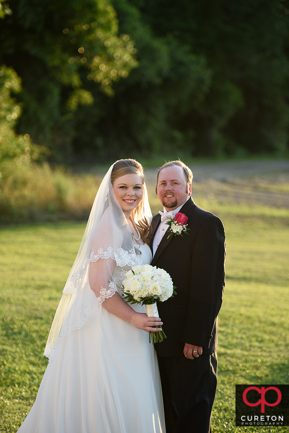 Couple posing for some shots after their Sumter,SC wedding.