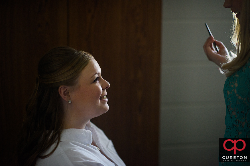 Bride getting her makeup applied.